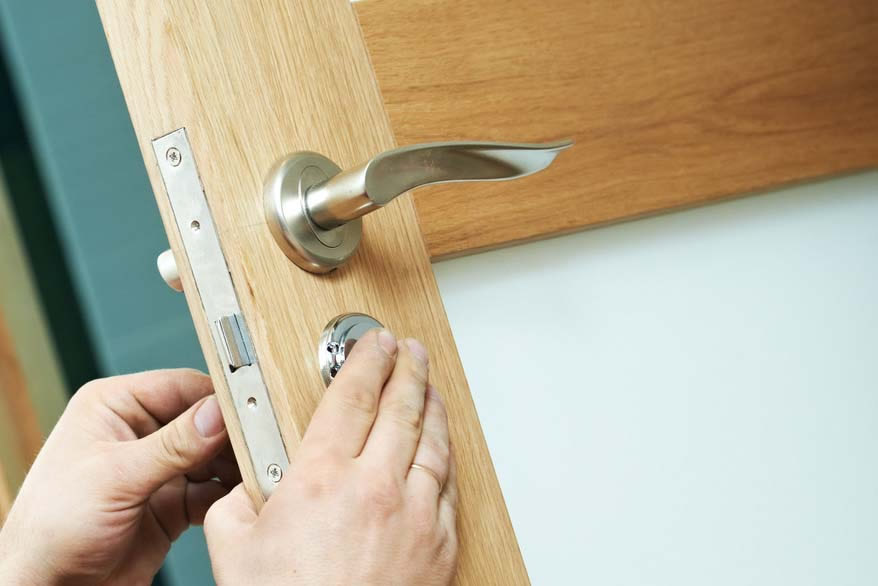 locksmith picking a door lock