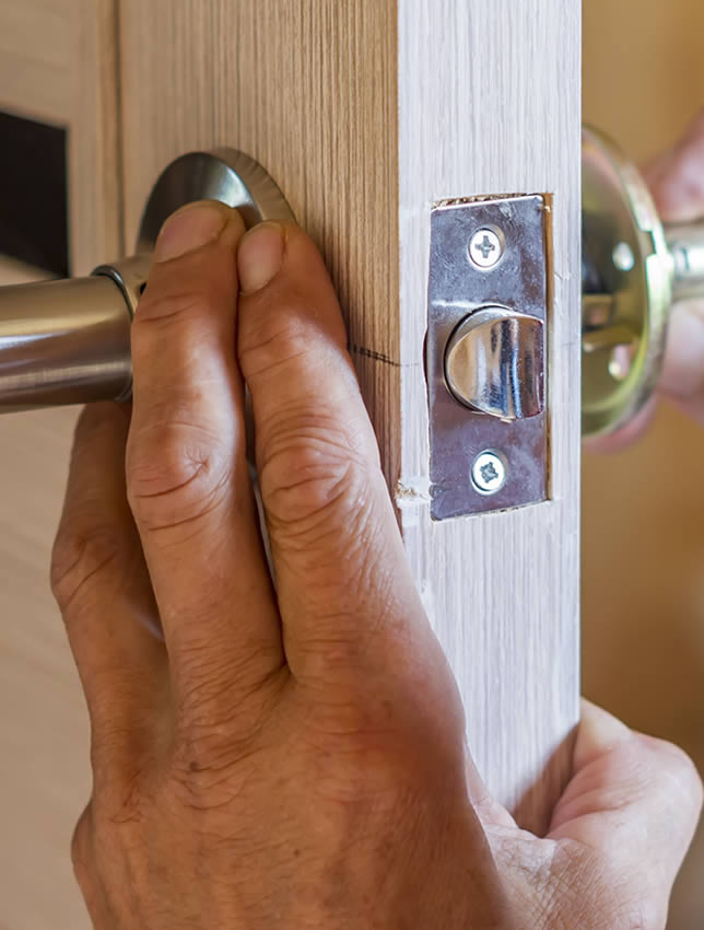 locksmith changing a door lock